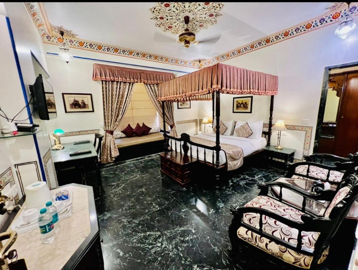 Royal Deluxe Room pickup from train or bus station on arrival Enjoy daily Rajasthani dance & music 7PM–9 PM swimming pool kids a dedicated travel desk to assist local sightseeing tours intercity travel activities,1402885844:JPEG